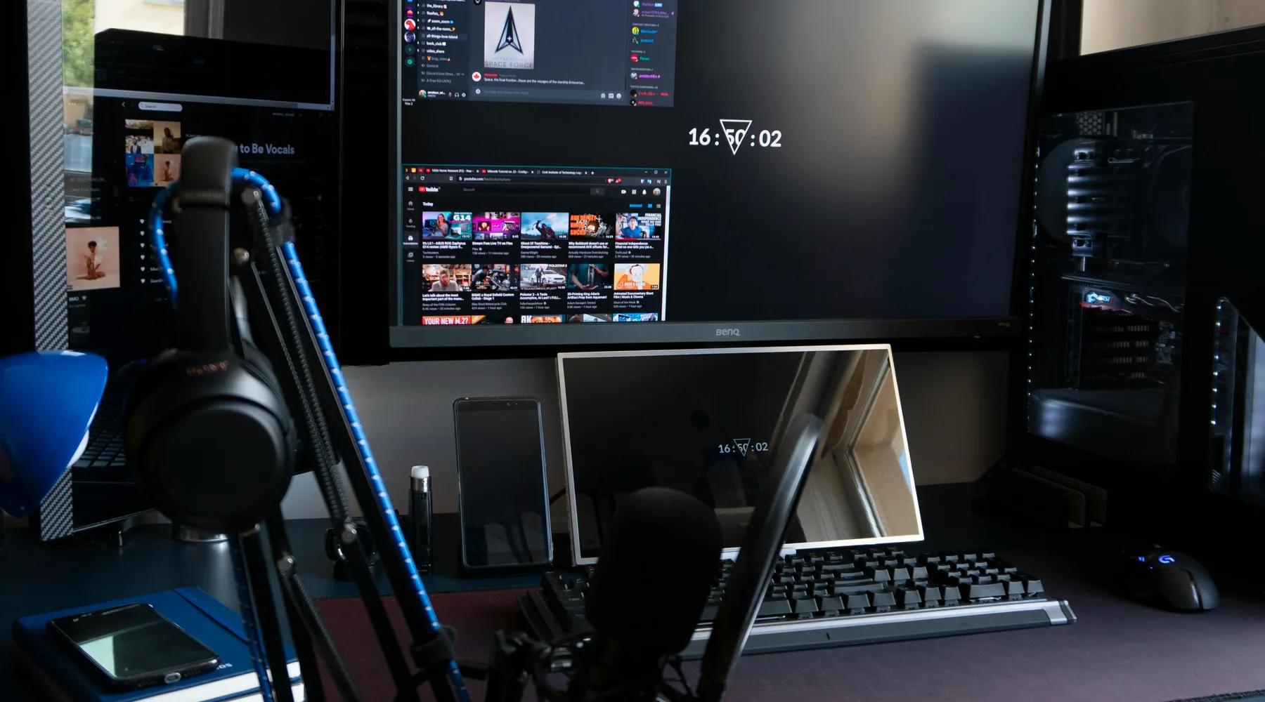 Gaming creator desk setup with monitors and streaming equipment